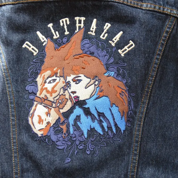 Large multi-colour illustrated design embroidered across the back of a denim jacket.